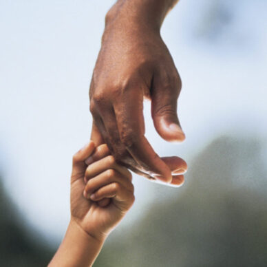 Child holding adult's hand